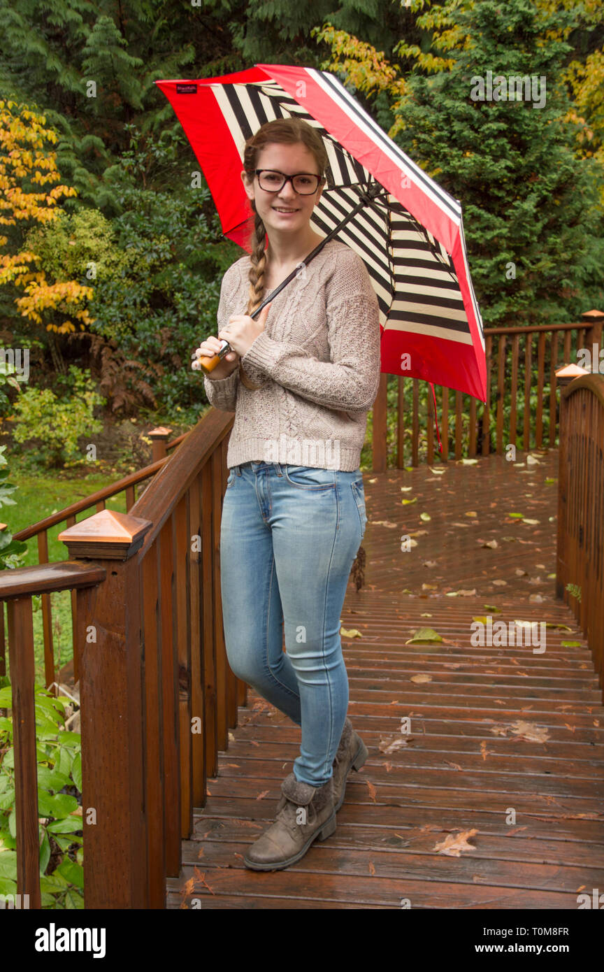 Teenage girl with an umbrella. Stock Photo