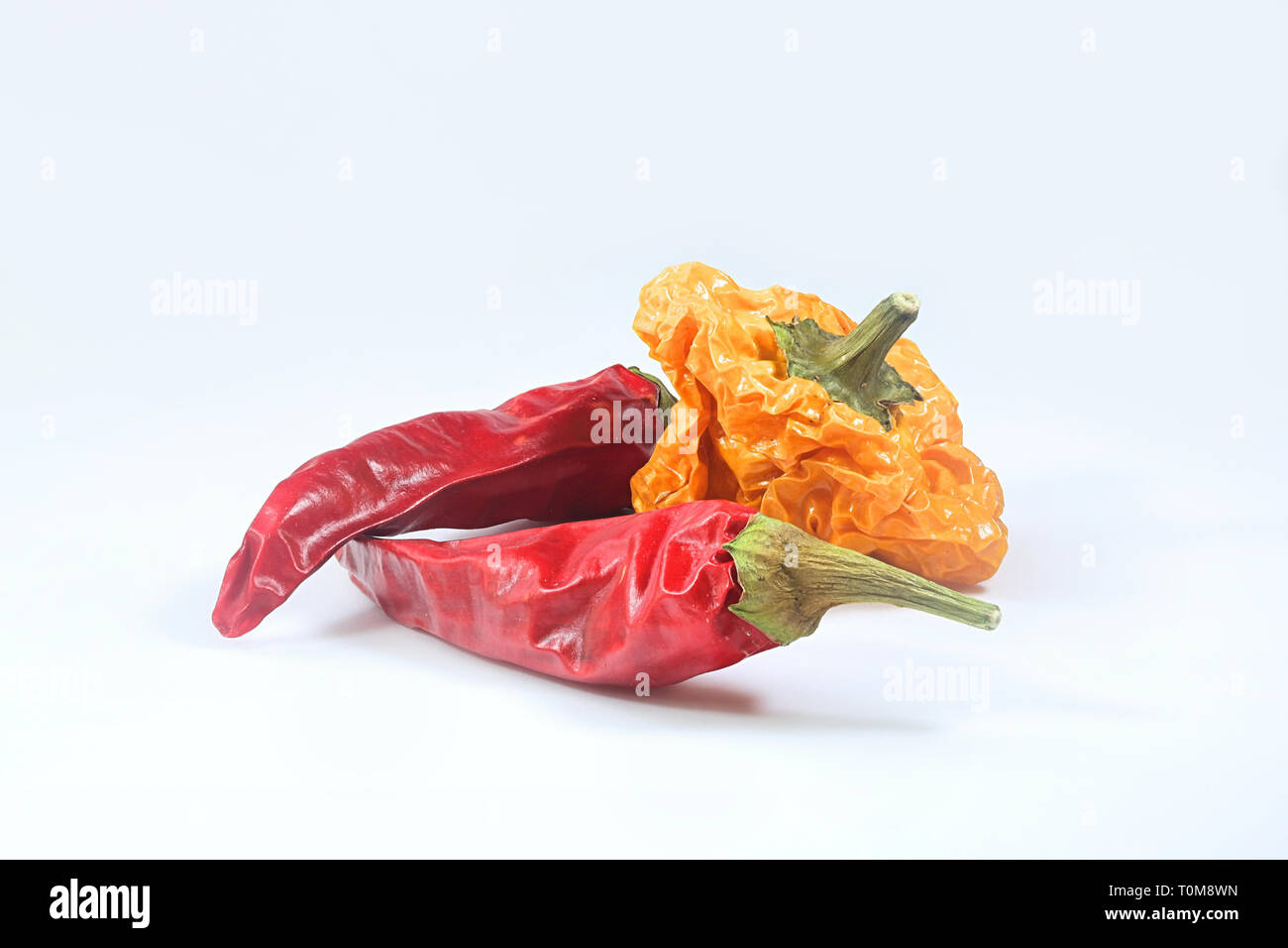 Red chili peppers and yellow habanero on white background Stock Photo