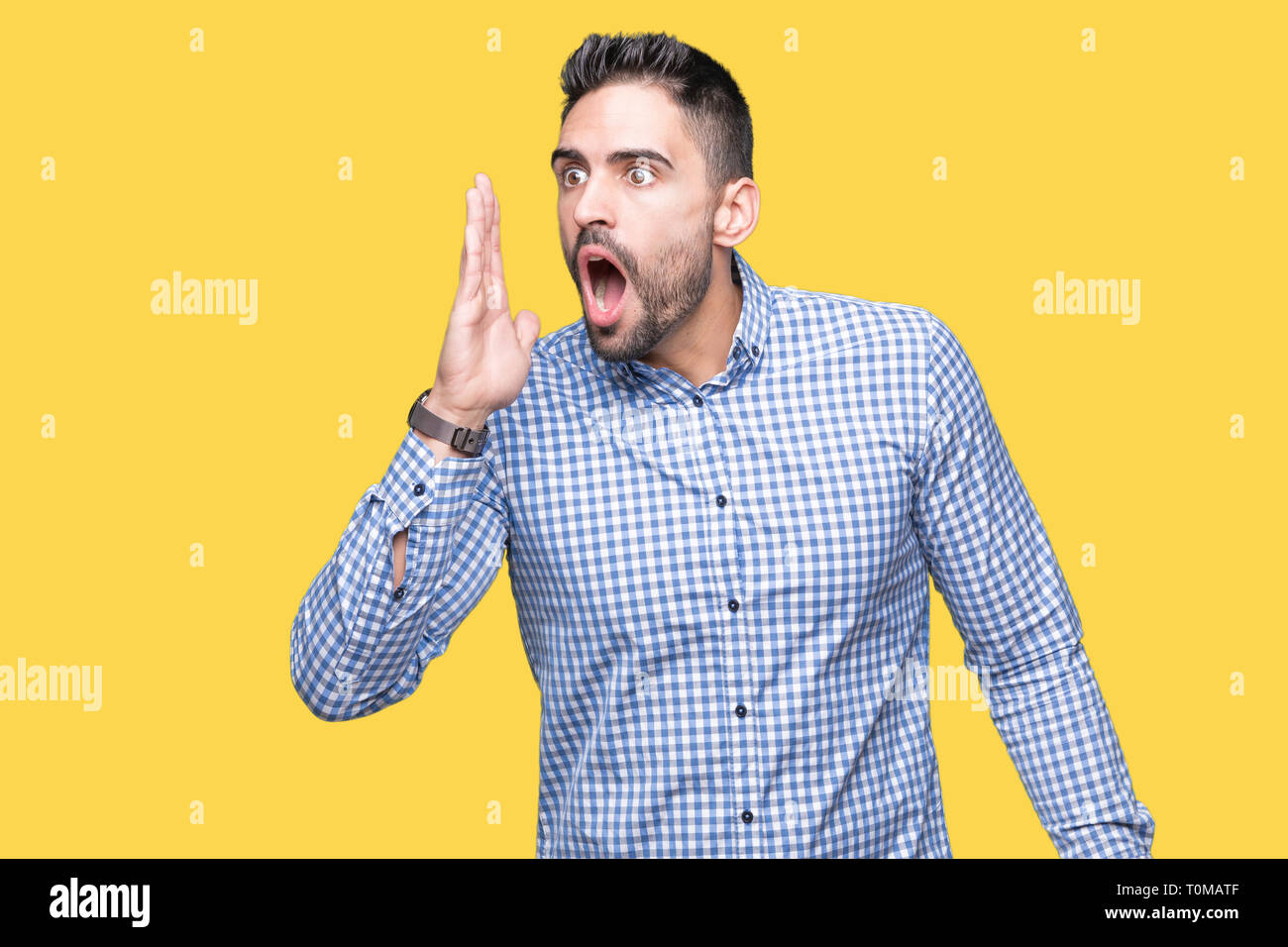 Young handsome man over isolated background shouting and screaming loud ...