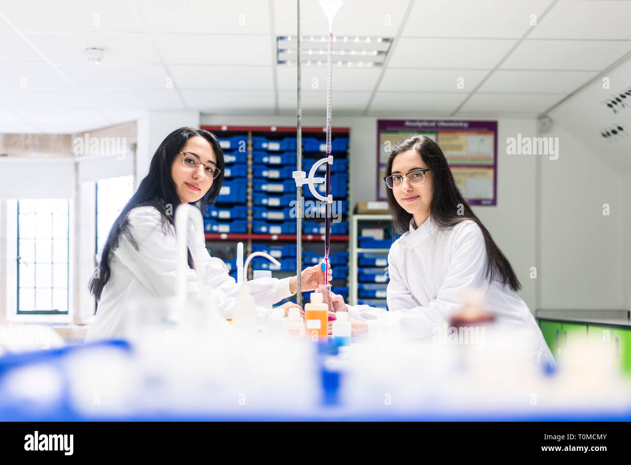 two twin sisters who are studying science in college in cambridge carry