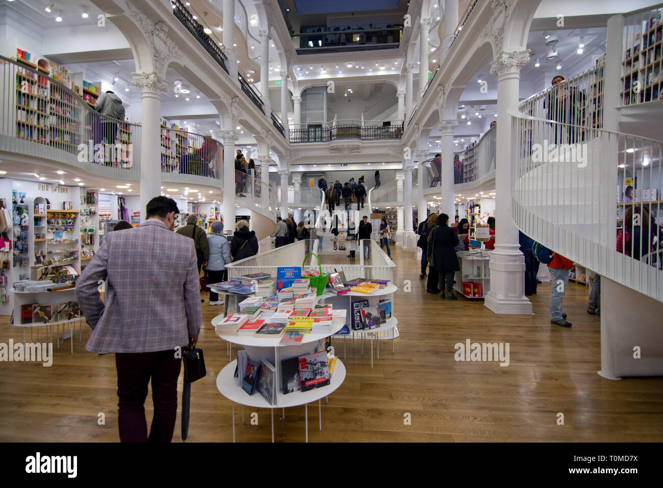 People inside library looking around at books. Stunning architecture interior design Stock Photo
