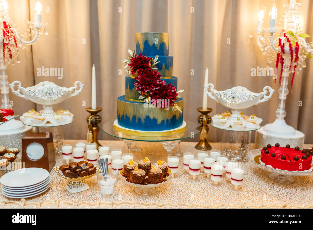 Candy Bar Blue Wedding Cake Decorated By Flowers Standing Of Festive Table With Deserts Strawberry Tartlet And Cupcakes Wedding Reception Tartlets Stock Photo Alamy