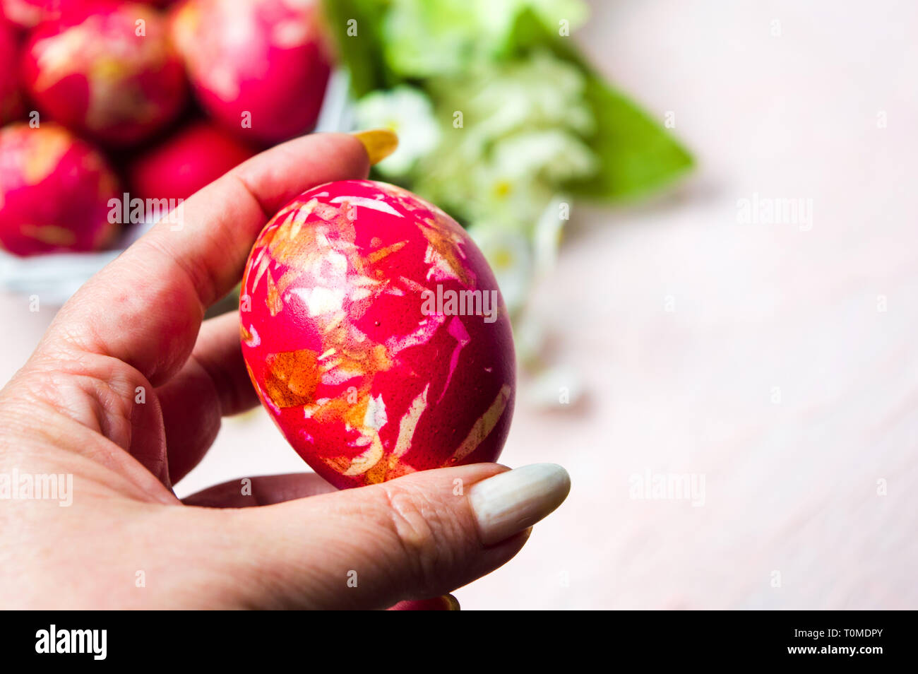Female hand holding an Easter egg first person view Stock Photo