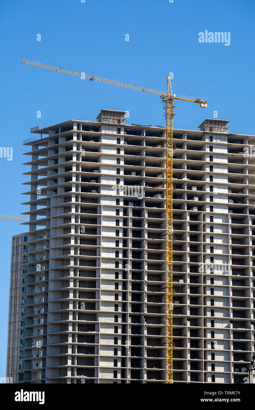 Construction of a highrise building with a crane. Building