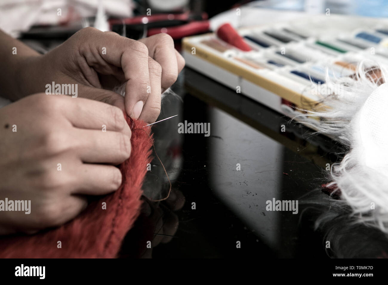 Seamstress working on a fox costume Stock Photo