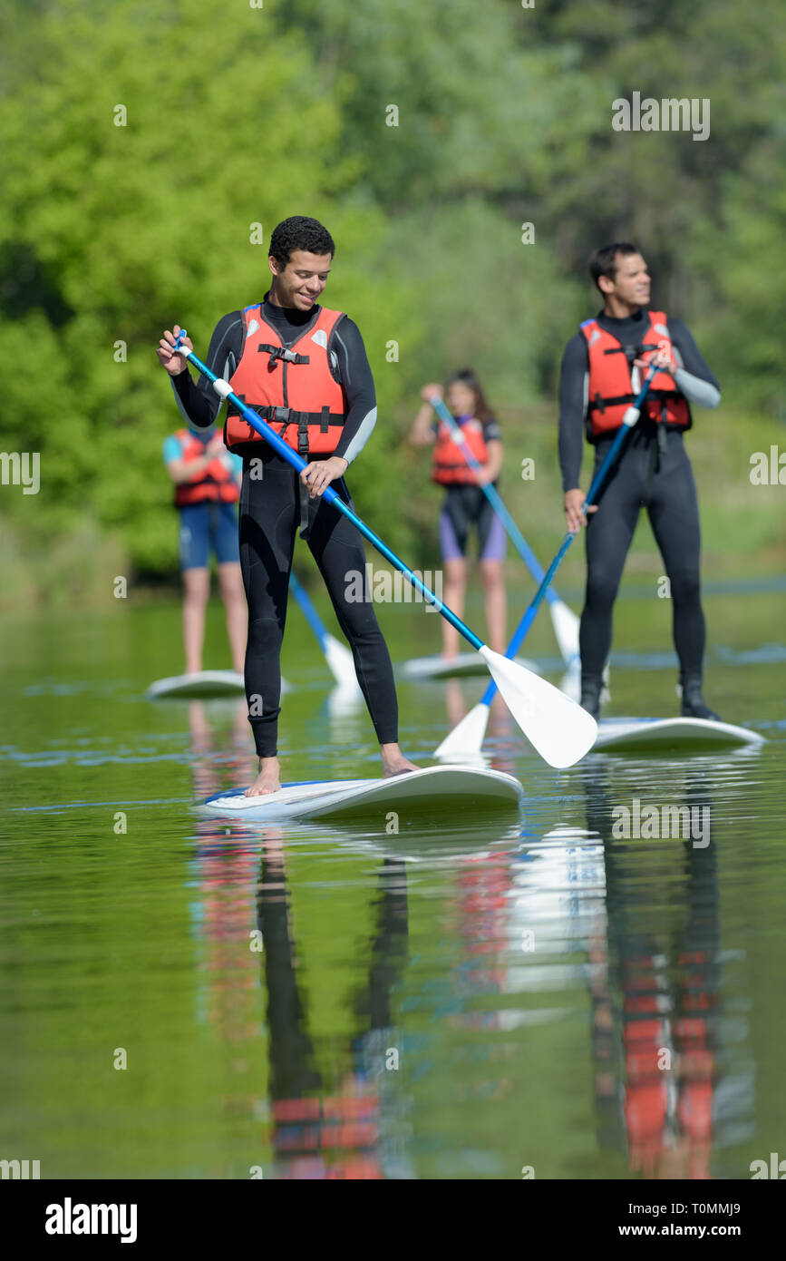 learning to do standing paddle boarding Stock Photo Alamy