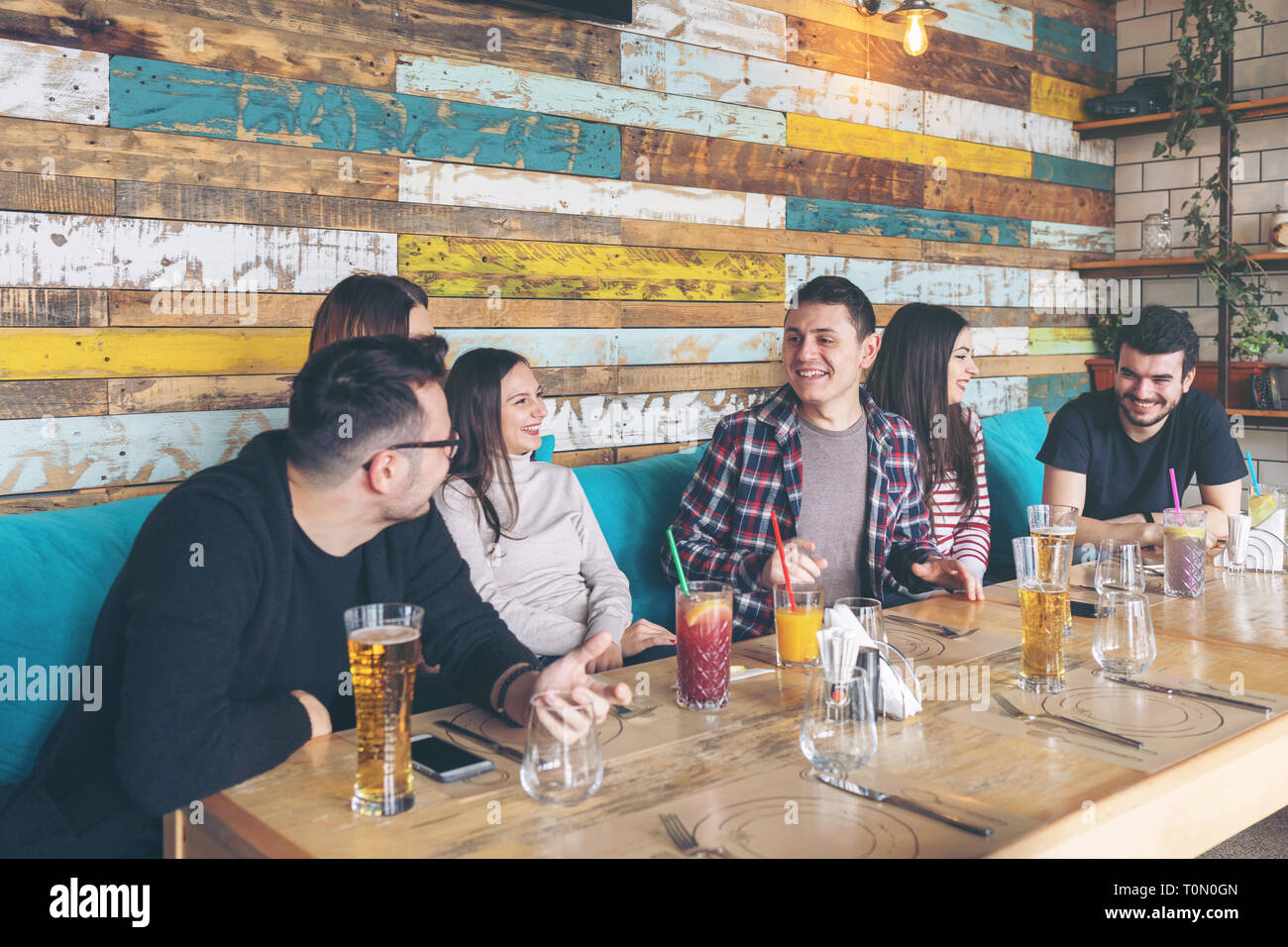 Happy group of best friends having fun together at trendy pub Stock Photo