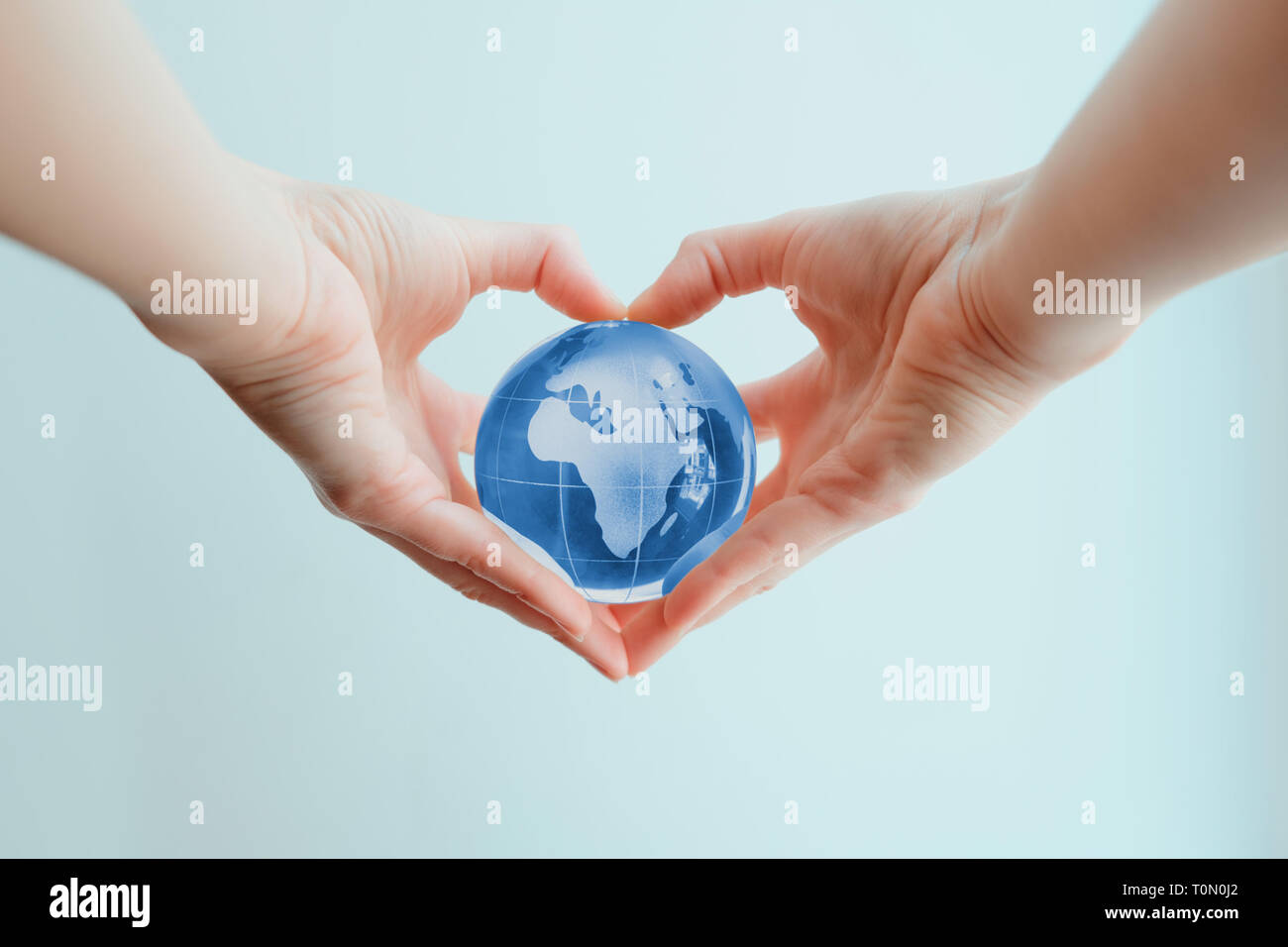 Hands holding globe africa hi-res stock photography and images - Alamy