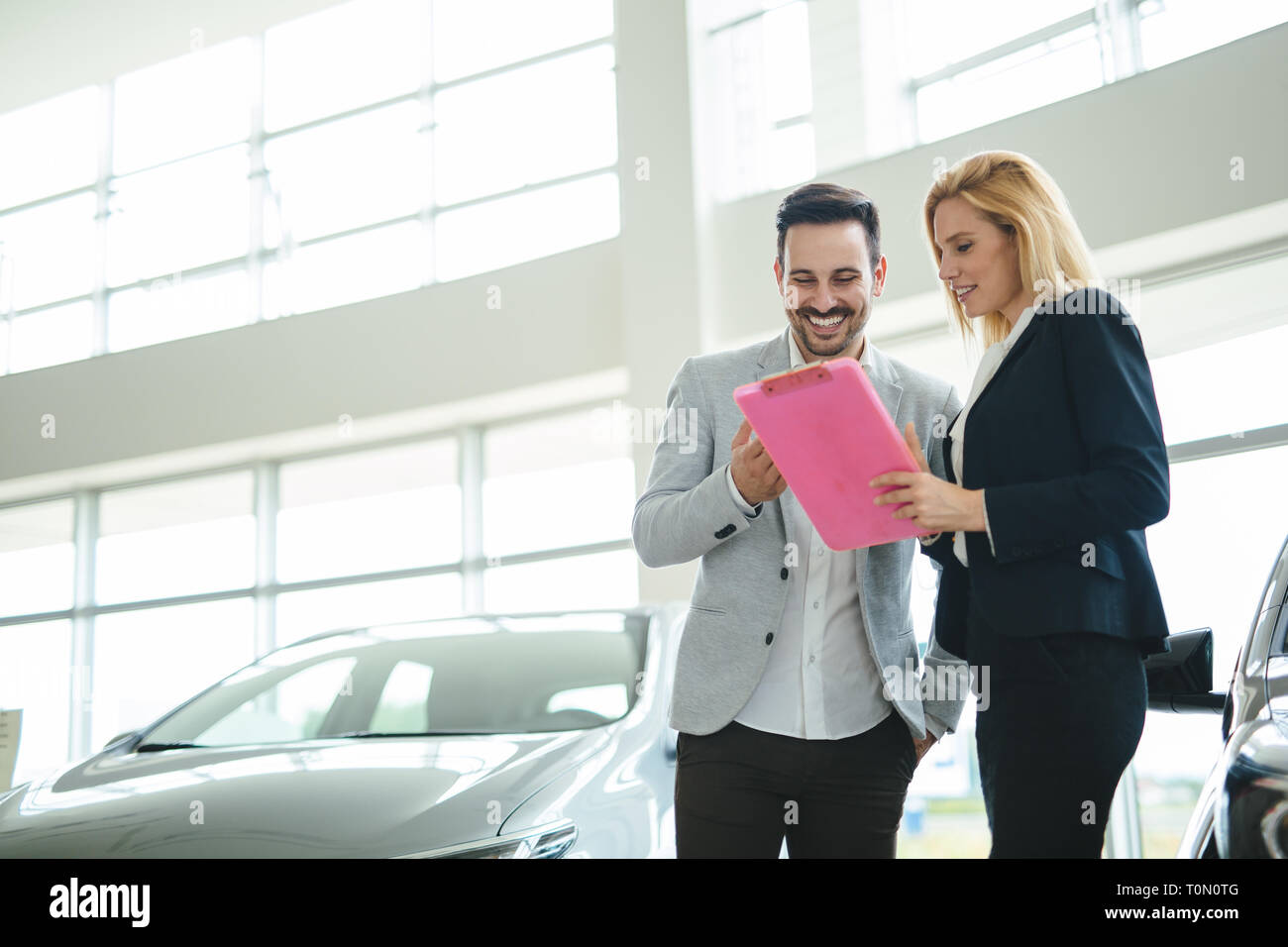 Portrait of happy customer buying new car Stock Photo