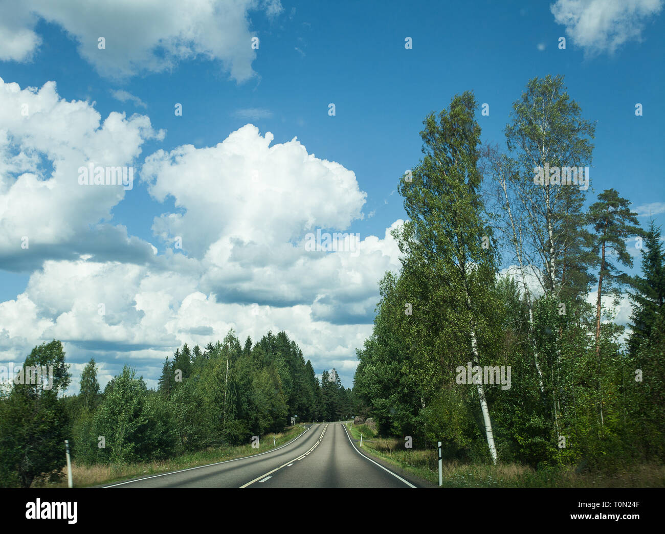 Fields, trees and road with blue sky and clouds Stock Photo - Alamy
