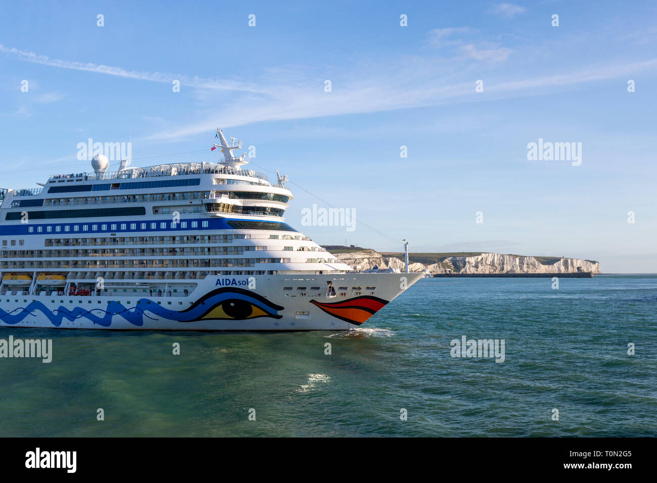 Aidasol cruise ship docking in the Port of Dover; with the iconic White Cliffs in the background. Stock Photo