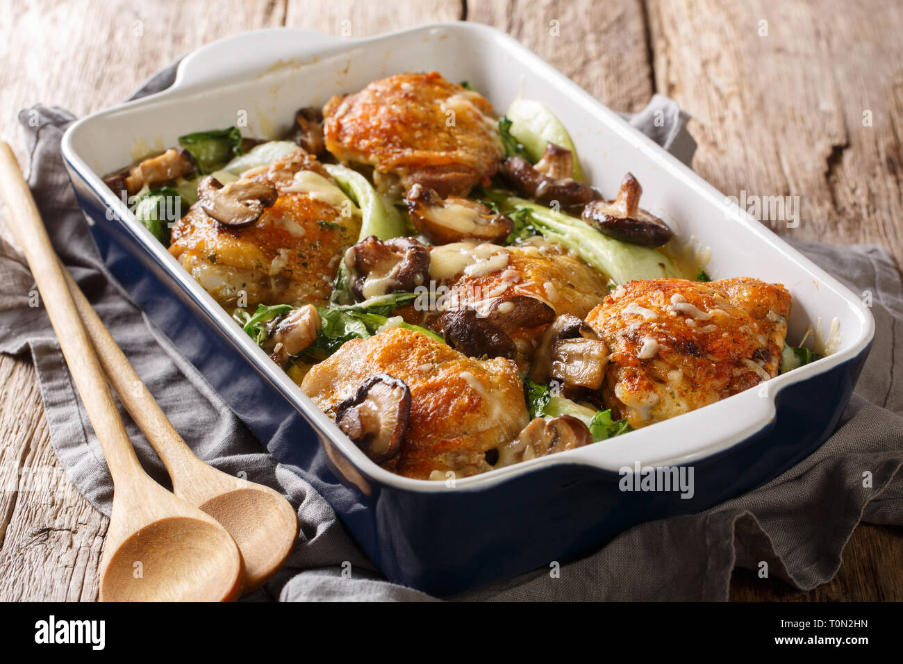 Homemade baked chicken thigh recipe with baby bok choy, shiitake