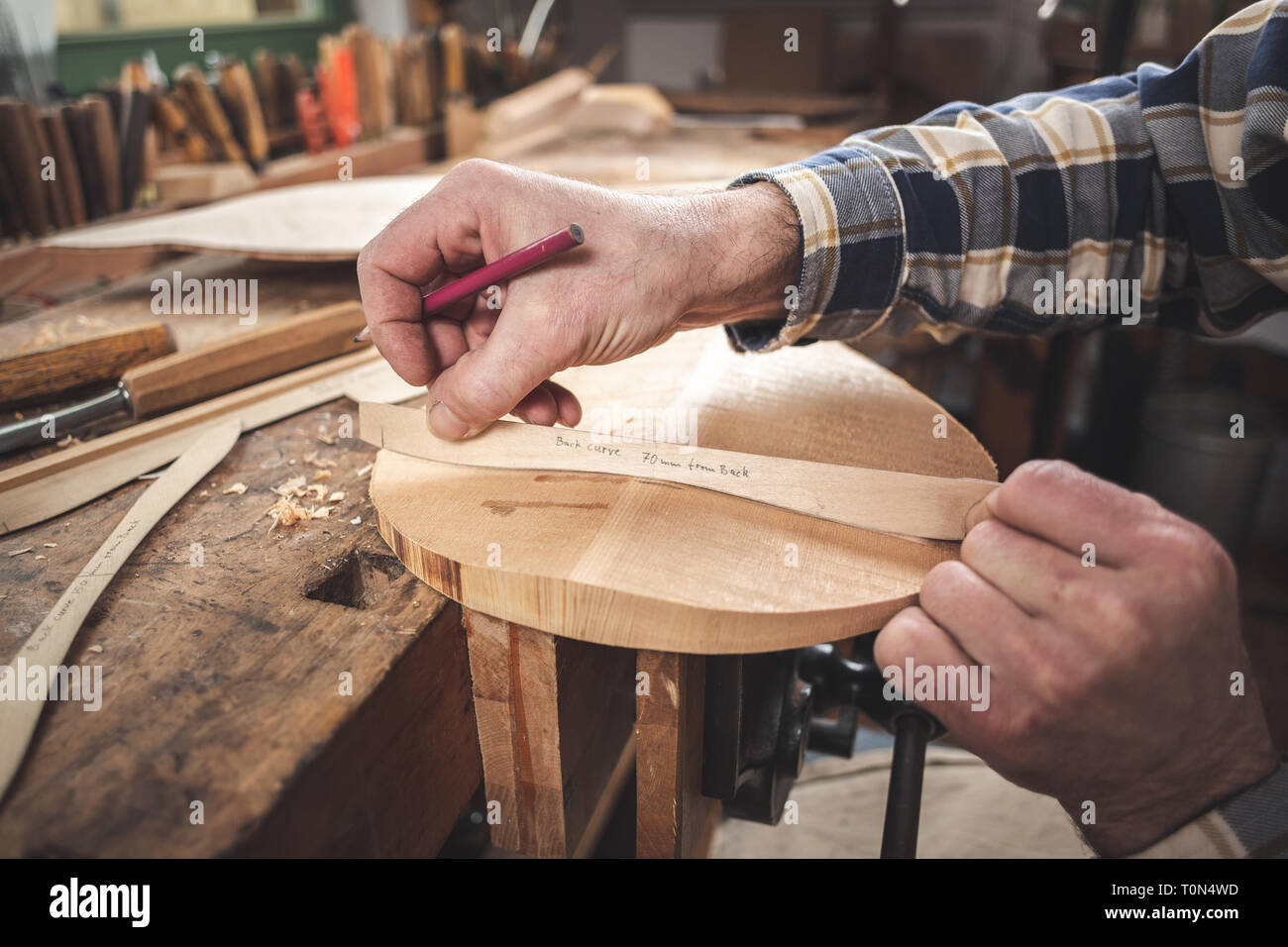 Instrument maker working on a mandolin Stock Photo