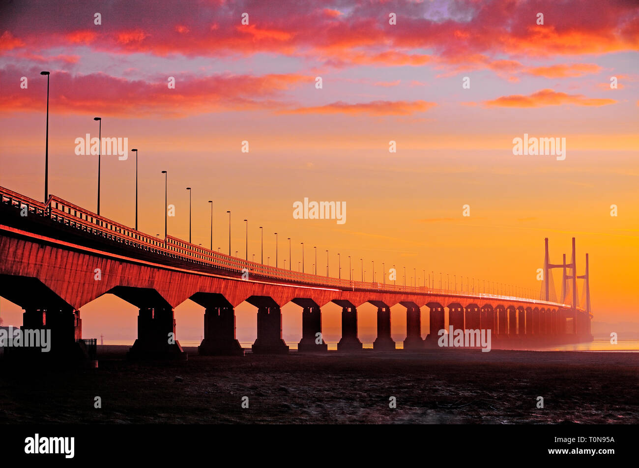 Great Britain, Wales, River Severn.  Severn Bridge at sunrise, straddling one of the largest tidal ranges in the world. Stock Photo