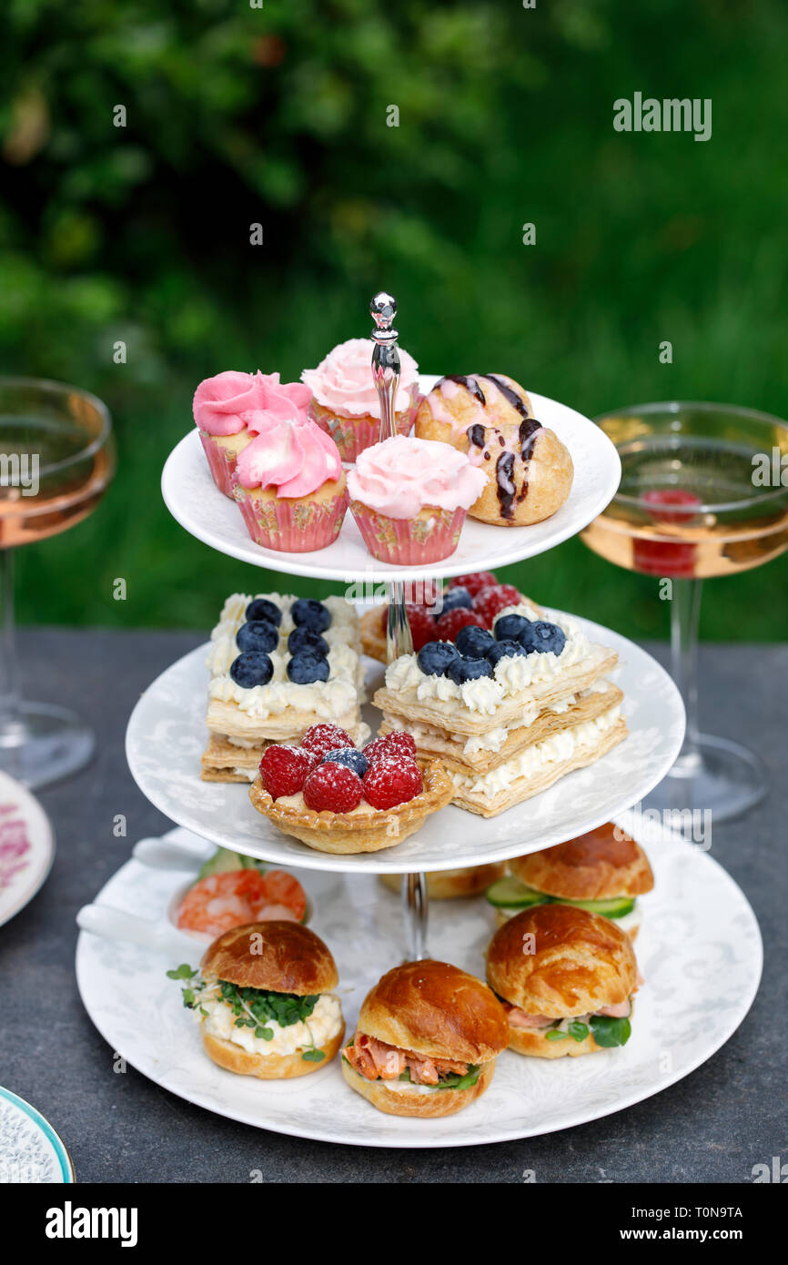 Afternoon tea with mini brioche canapes and selection of sweets Stock Photo  - Alamy