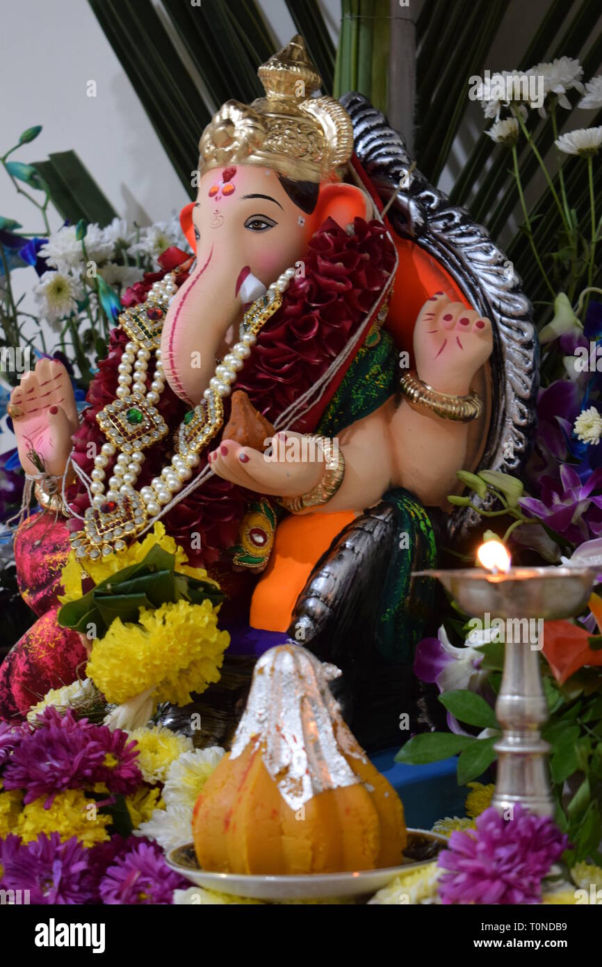 Lord Ganesh with his favourite Modak or sweet dumpling during Ganesh Puja celebration Stock Photo