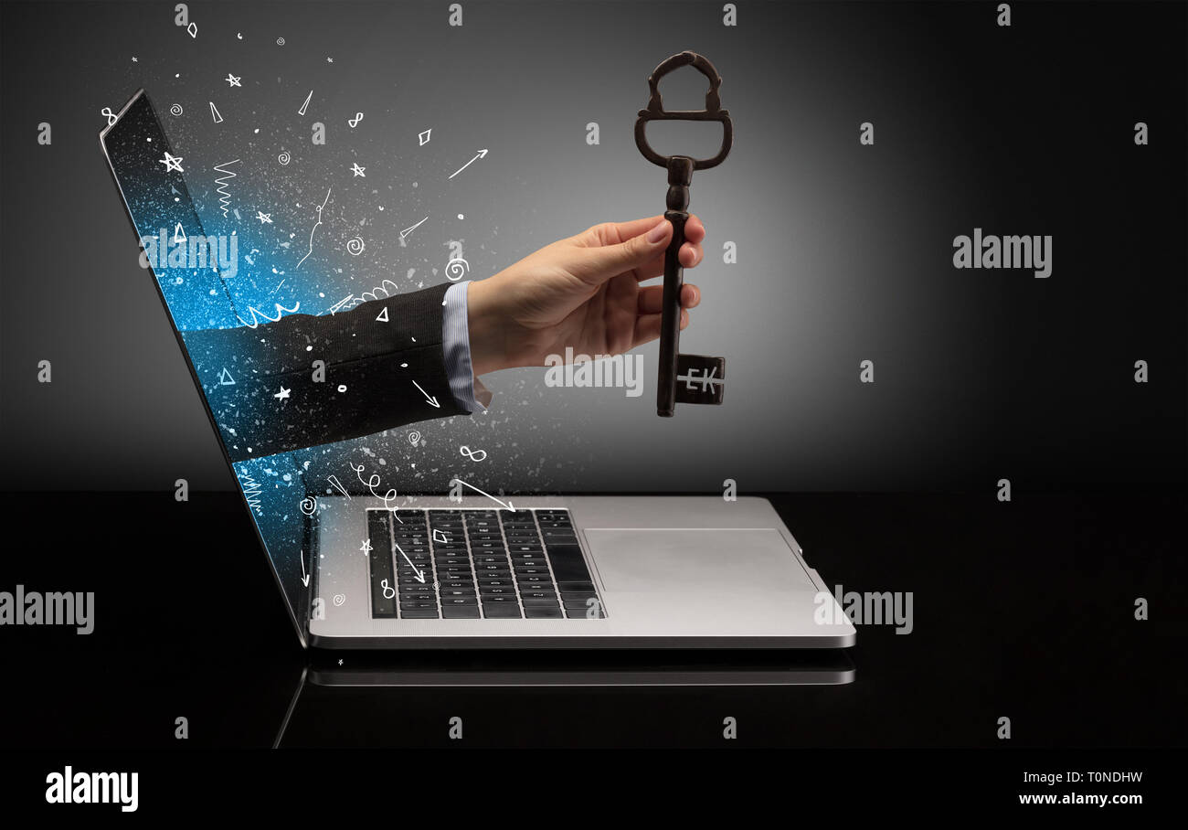 Hand with huge vintage key coming out of a laptop with sparkling