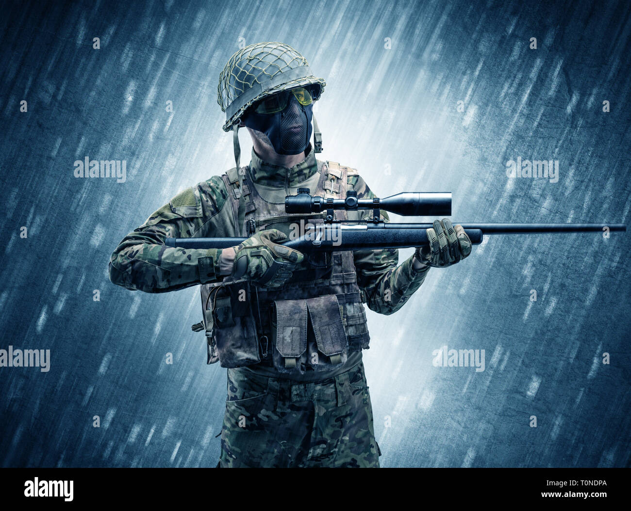 Armed soldier standing in rainy weather  Stock Photo