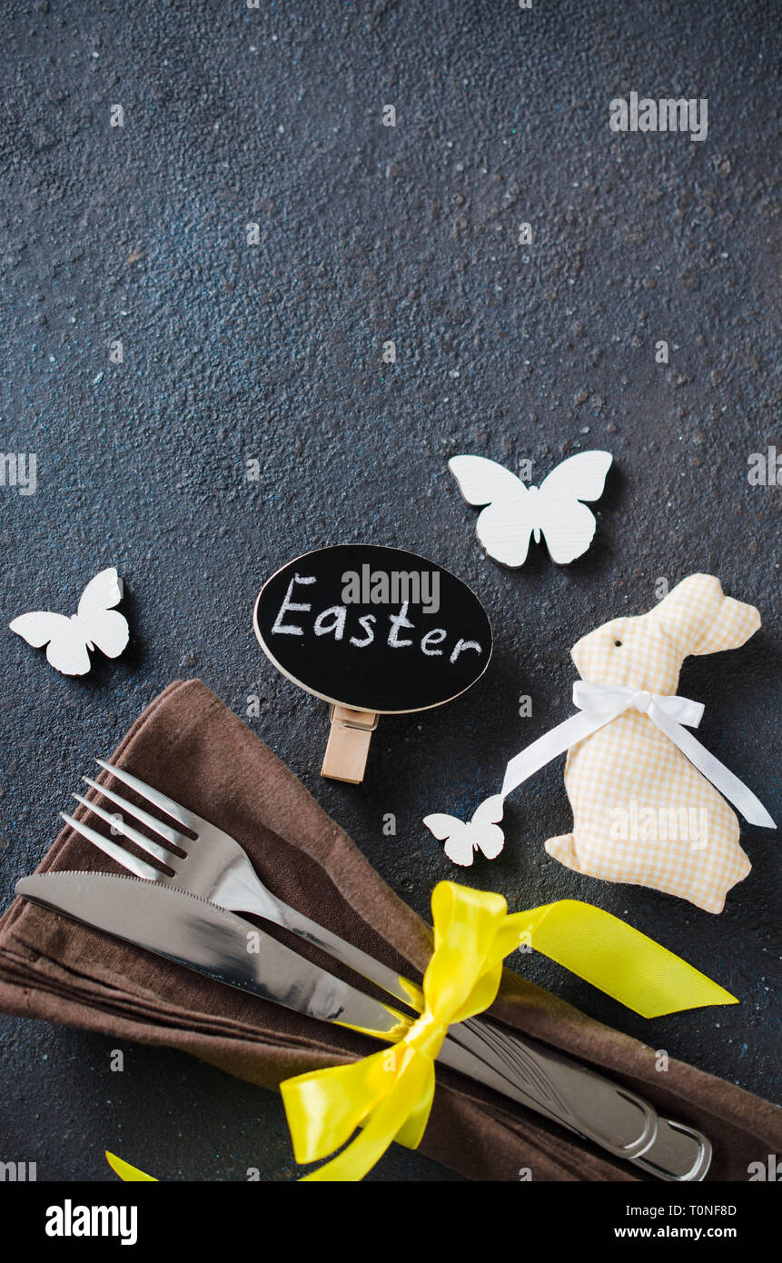 Festive table setting for holiday Easter dinner on dark table. Holidays background with copy space. Stock Photo