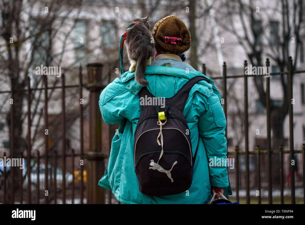 18.02.2019. RIGA, LATVIA. Woman walking on the street with her cat on shoulder. Stock Photo