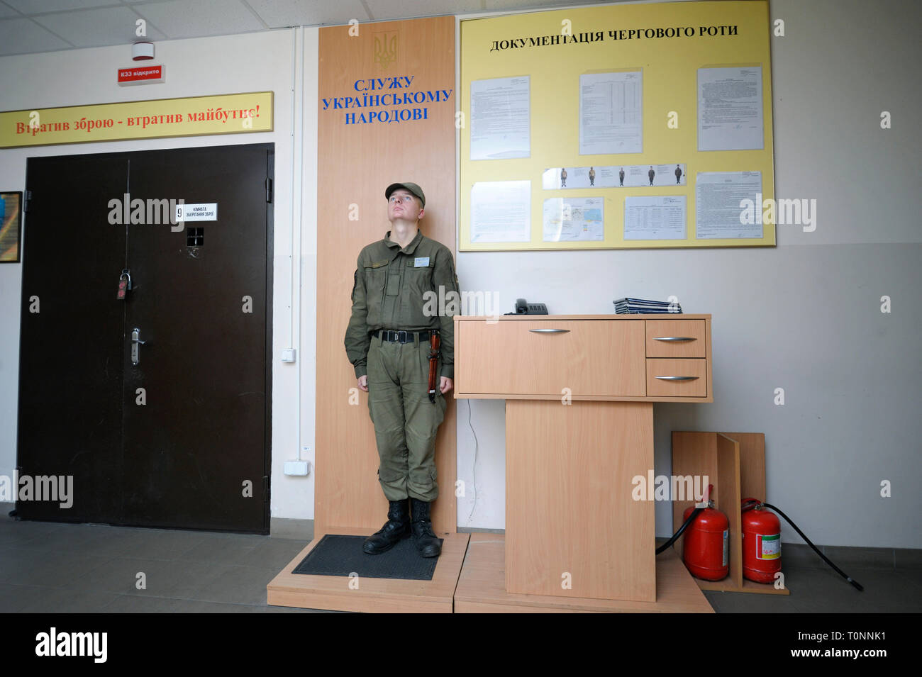 Orderly Man Salutes To An Officer Passing By A Corridor Of