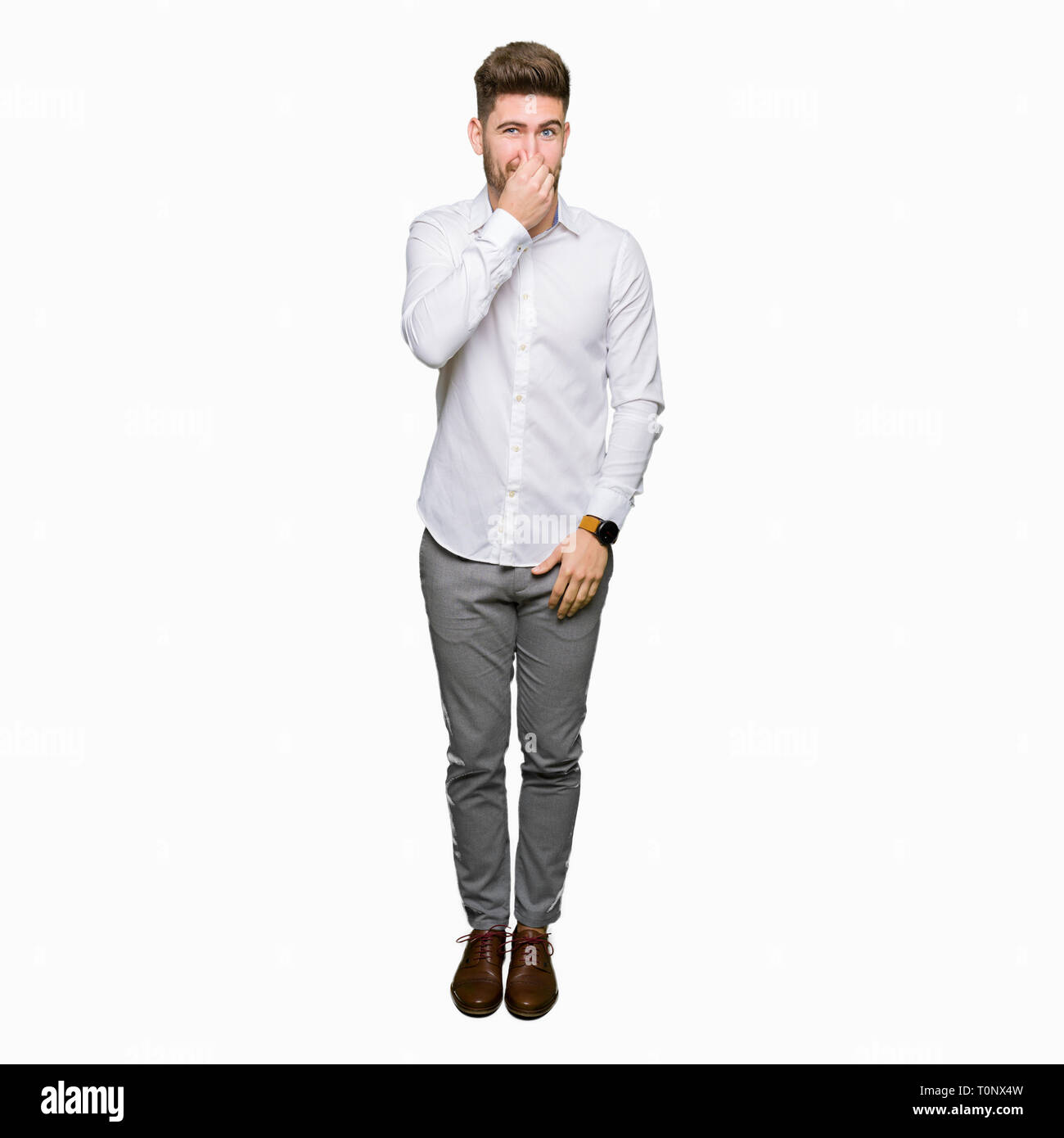 Young handsome business man smelling something stinky and disgusting,  intolerable smell, holding breath with fingers on nose. Bad smells concept  Stock Photo - Alamy, image size:1300x1390