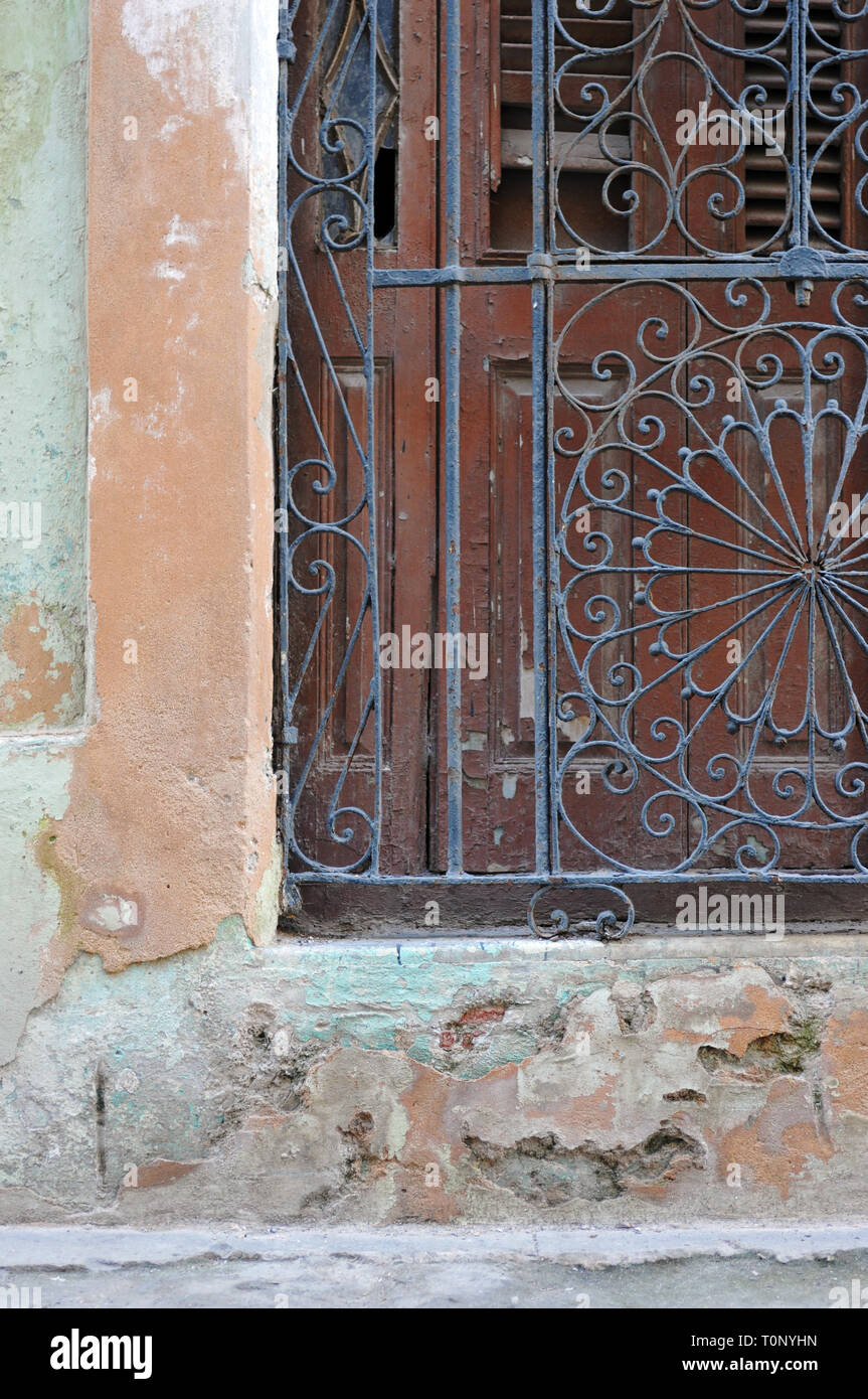 Detail of architectural features including an ornate iron gate and wooden door at the entrance to a building in Old Havana, Cuba. Stock Photo