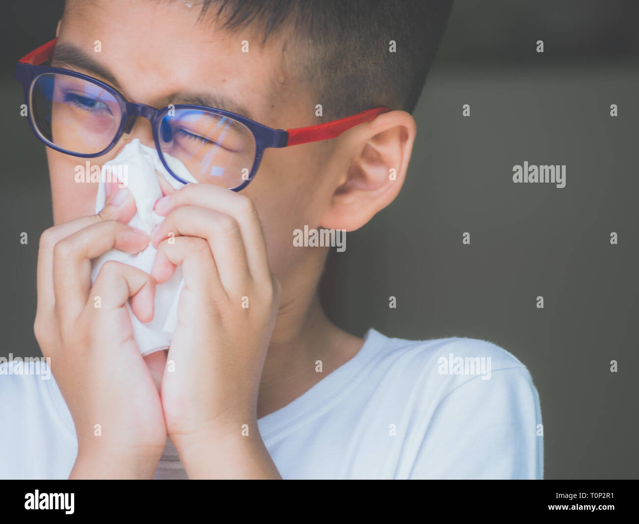 Boy get cold and blow runny nose with tissue. health concept. Stock Photo