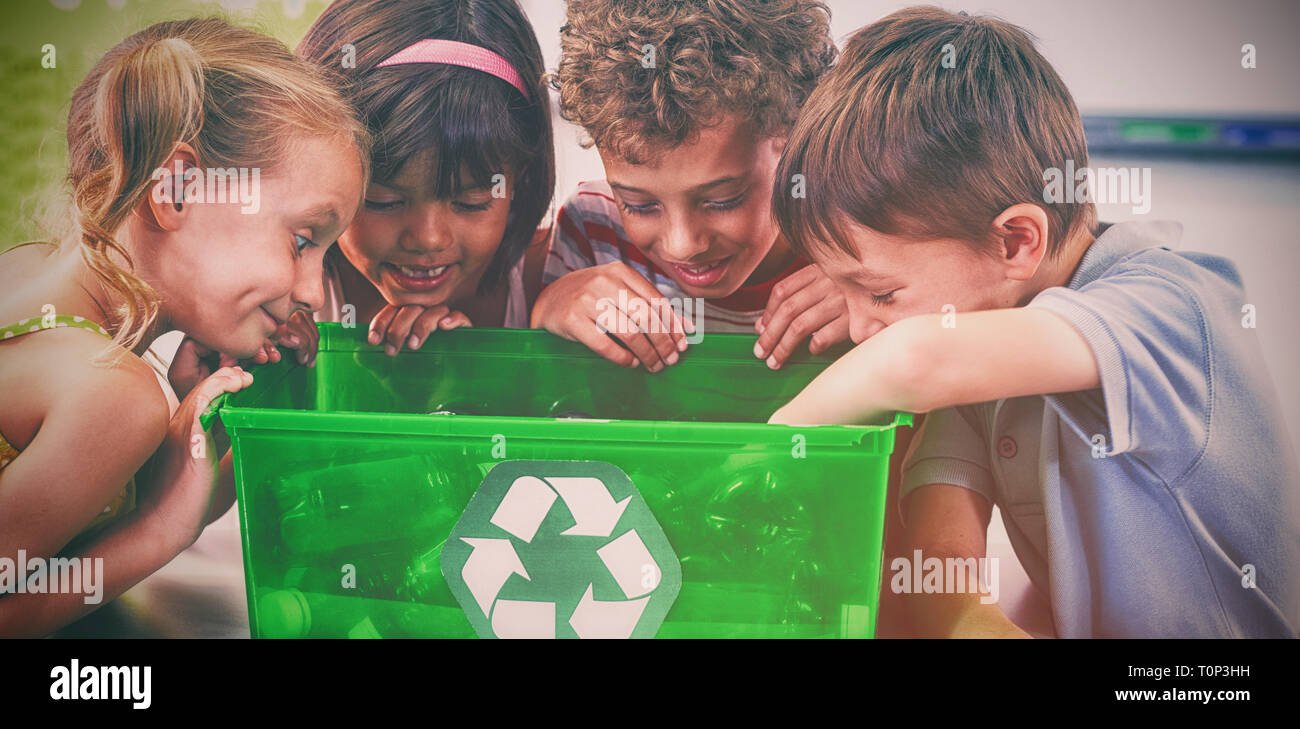 Children looking in green box Stock Photo