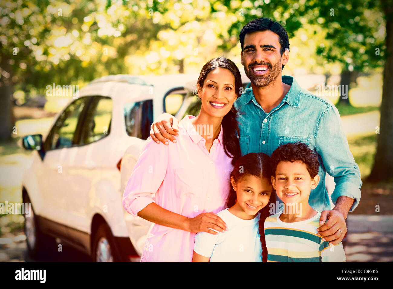 Happy family on a picnic standing next to their car Stock Photo