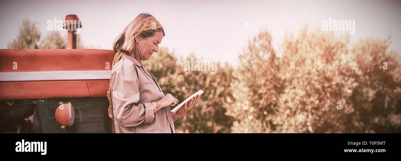 Woman using digital tablet in farm Stock Photo