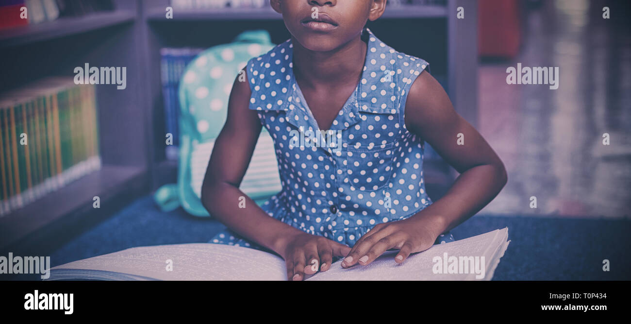 Girl reading braille book in library Stock Photo Alamy