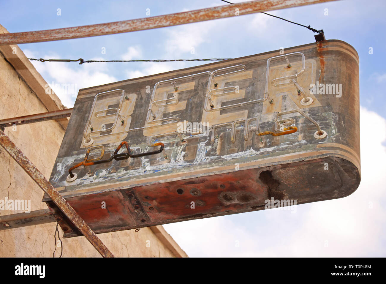 A beer sign marks the location of a long abandoned bar in the American Southwest. Stock Photo