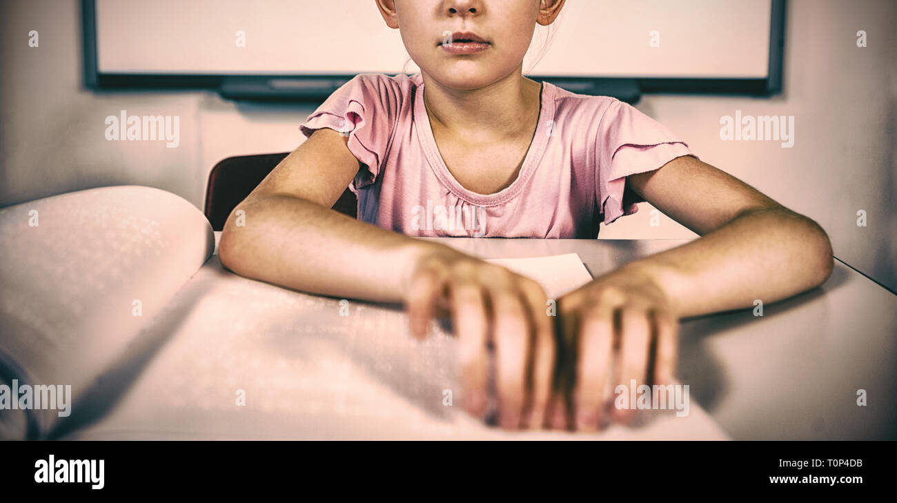 Schoolgirl reading a braille book in classroom Stock Photo Alamy