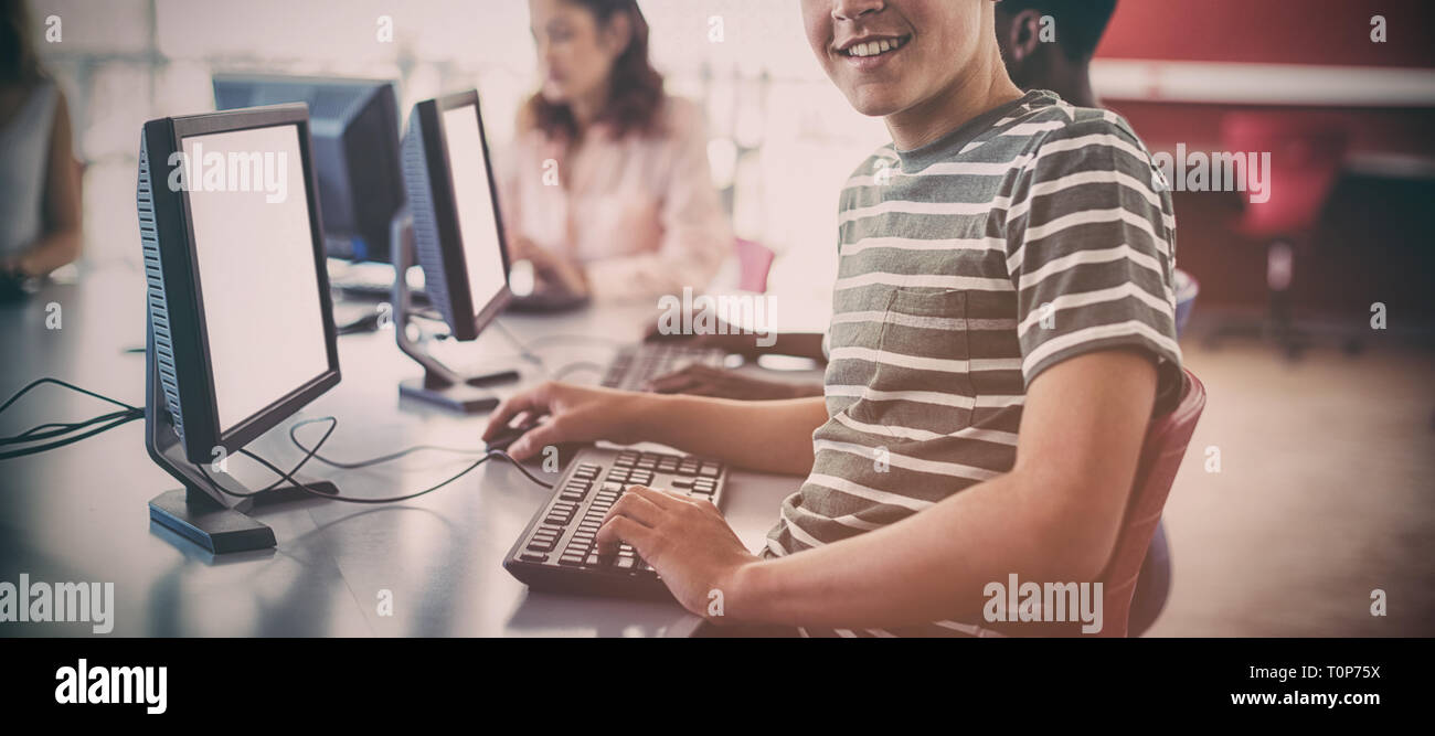 Student using computer in classroom Stock Photo