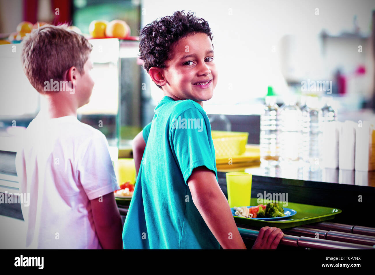 Schoolboy with classmate standing near canteen counter Stock Photo