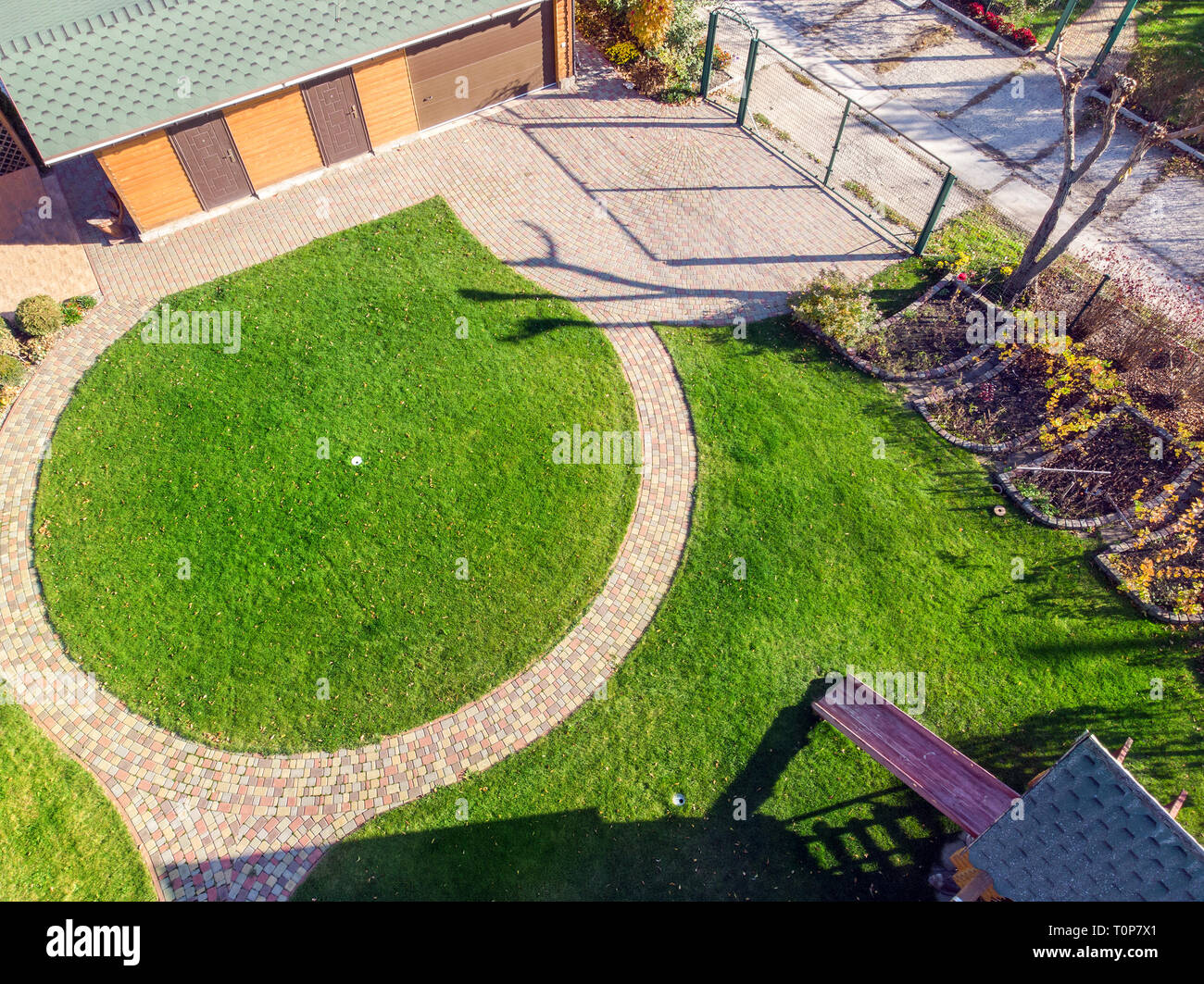 Aerial Drone View Of Backyard Garden With Circle Wath Path Green