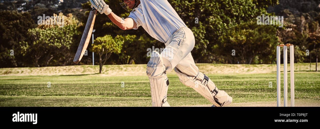 Full length of cricketer playing on field Stock Photo
