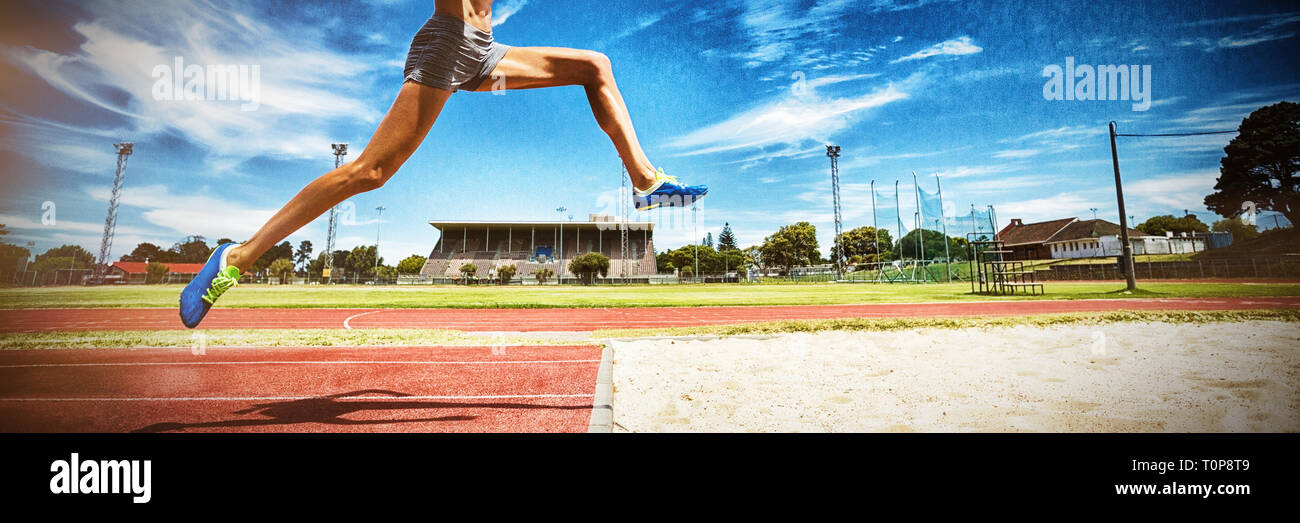Female athlete performing a long jump Stock Photo Alamy