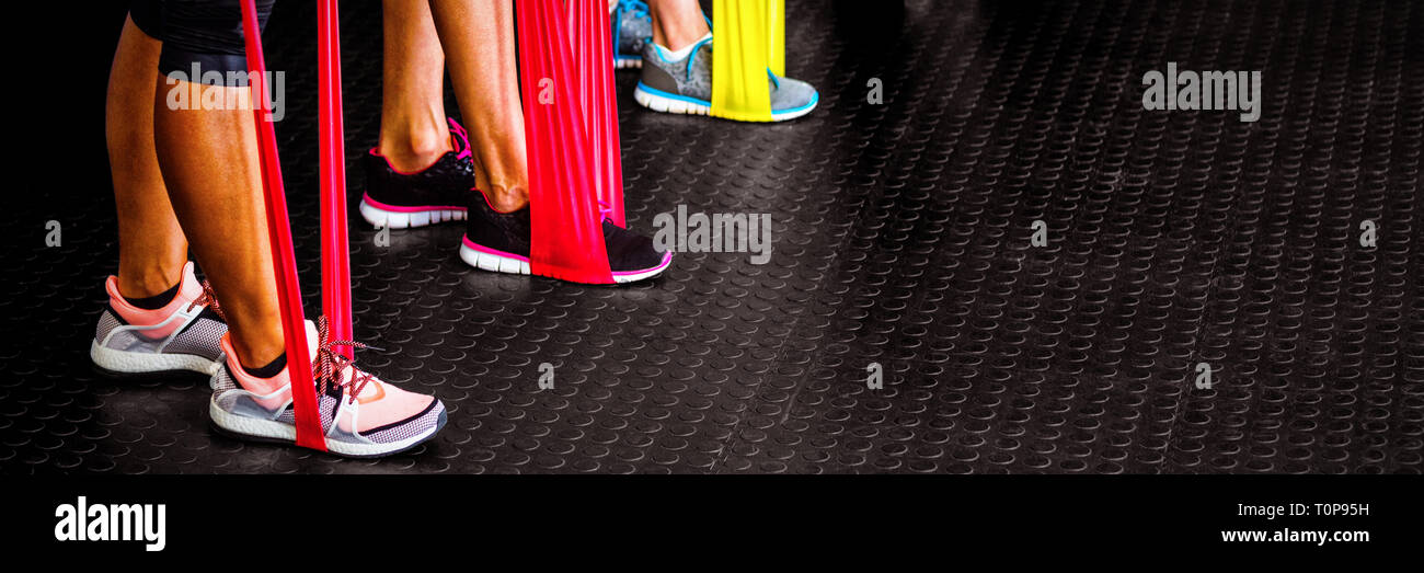 Low section of athletes exercising with resistance band Stock Photo