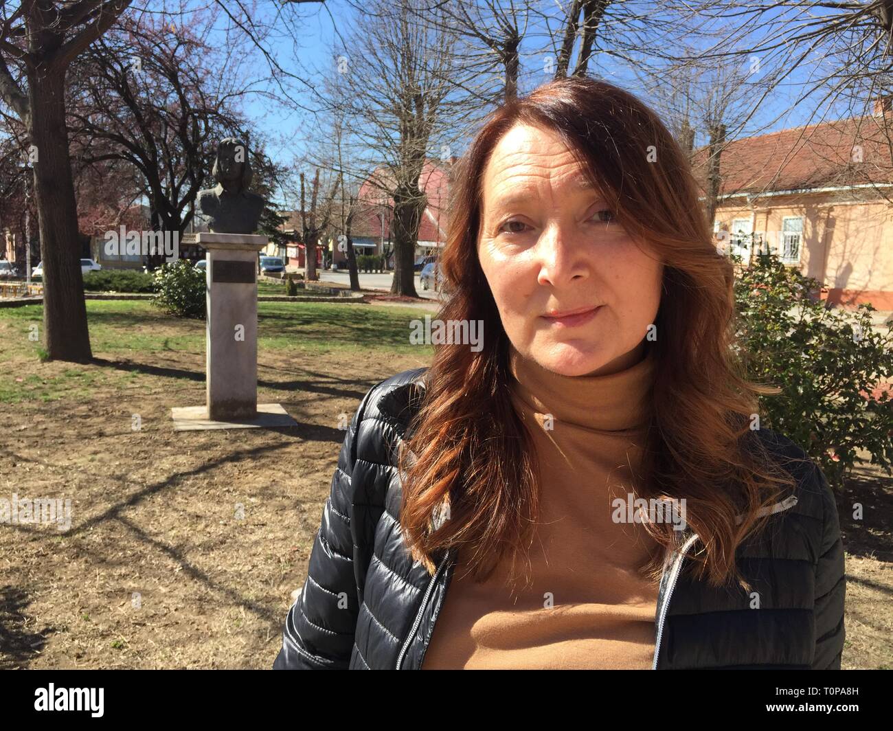 17 March 2019, Serbia, Varvarin: Vesna Milenkovic, whose daughter Sanja was killed in an attack on a bridge in a small Serbian town on 30 May 1999, in front of a bust erected in memory of the girl. 20 years ago, German soldiers were fighting again for the first time since the Second World War. On 24.03.1999 NATO attacks Serbian forces in the Albanian province with fighter planes and cruise missiles. From the Italian air base Piacenza also German Tornados ascend to the mission. Later, the bombing of a bridge in the central Serbian town of Varvarin, where 15-year-old Sanja Milenkovic died after  Stock Photo