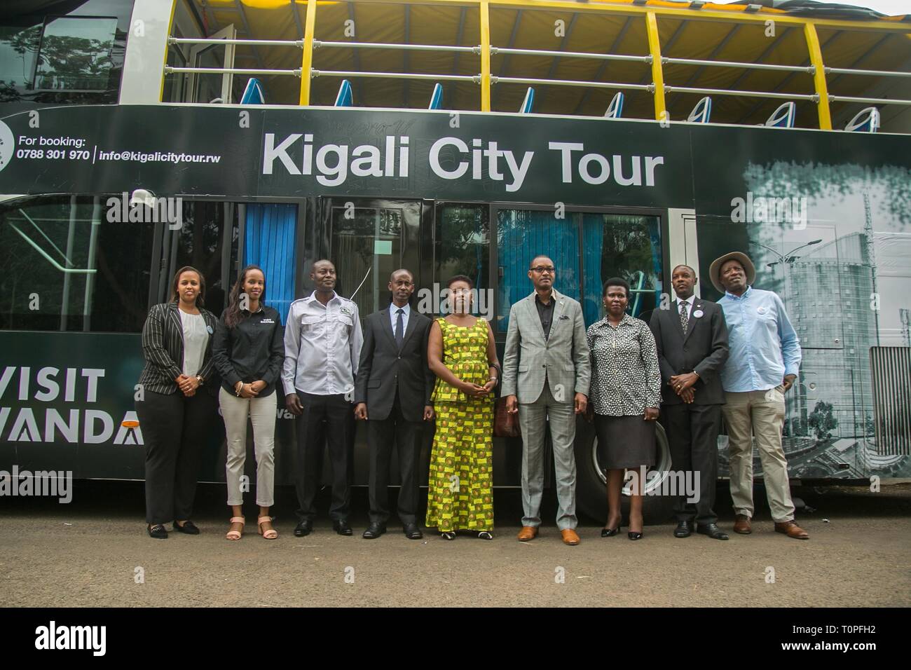 Kigali, Rwanda. 21st Mar, 2019. Guests pose for a photo in front of Kigali's first double-decker tour bus at its unveiling ceremony in Kigali, capital of Rwanda, on March 21, 2019. Rwanda Development Board in collaboration with Kigali City Tour Limited, a private company, on Thursday unveiled Kigali's first double-decker tour bus, which will be used for sightseeing in the city. Credit: Cyril Ndegeya/Xinhua/Alamy Live News Stock Photo