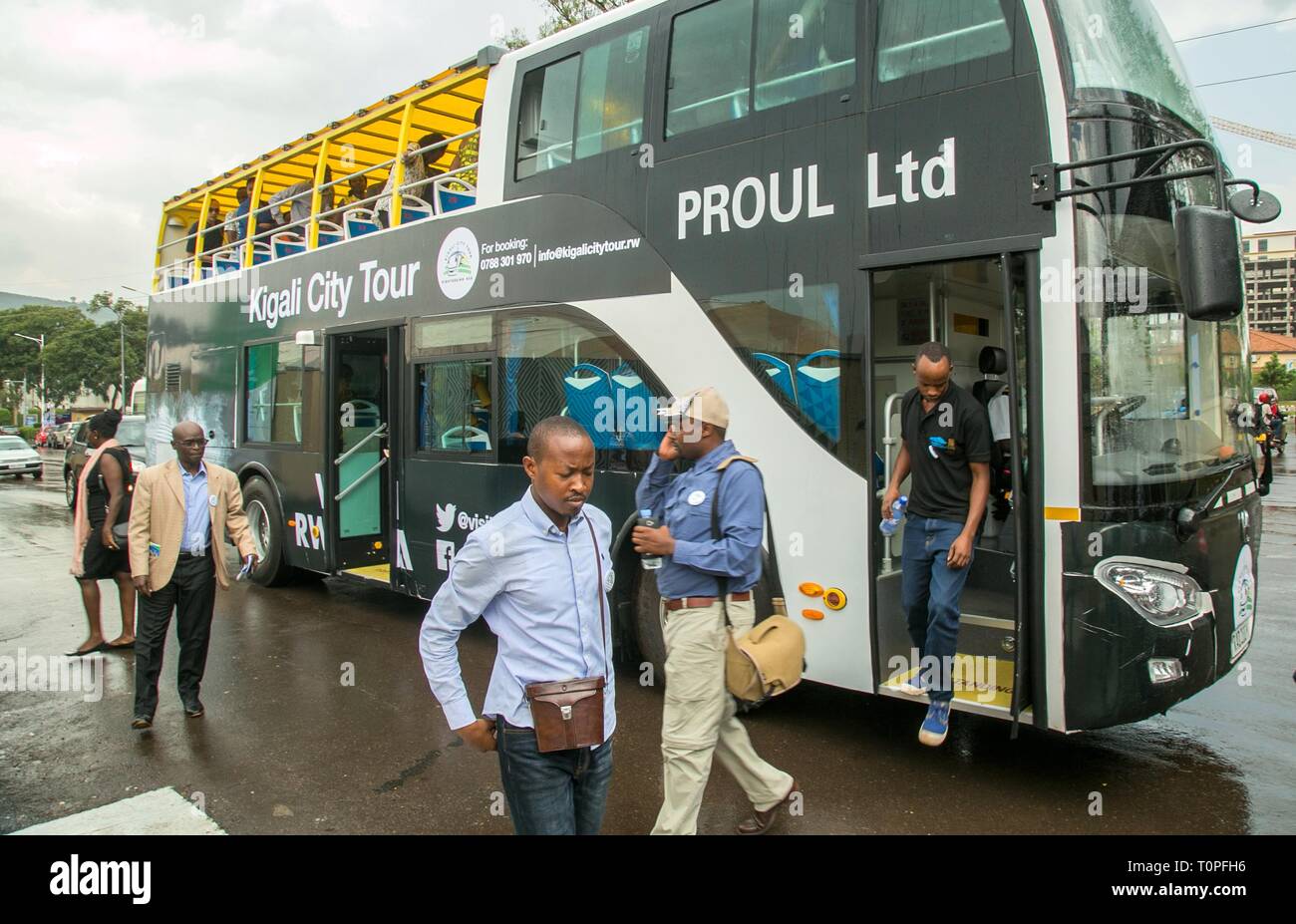 Kigali, Rwanda. 21st Mar, 2019. Passengers get off Kigali's first double-decker tour bus following its unveiling ceremony in Kigali, capital of Rwanda, on March 21, 2019. Rwanda Development Board in collaboration with Kigali City Tour Limited, a private company, on Thursday unveiled Kigali's first double-decker tour bus, which will be used for sightseeing in the city. Credit: Cyril Ndegeya/Xinhua/Alamy Live News Stock Photo