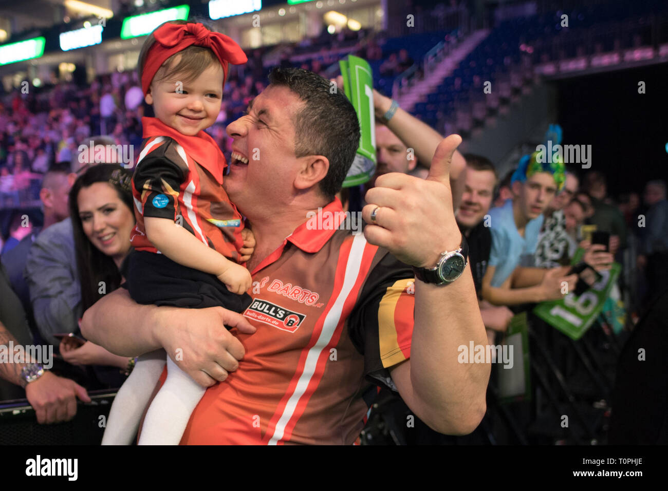 Berlin, Germany. 21st Mar, 2019. The Austrian darts professional Mensur  Suljovic and his daughter Emma are delighted with their victory in the  Premier League at the sold-out Ostbahnhof Arena. Credit: Jörg  Carstensen/dpa/Alamy