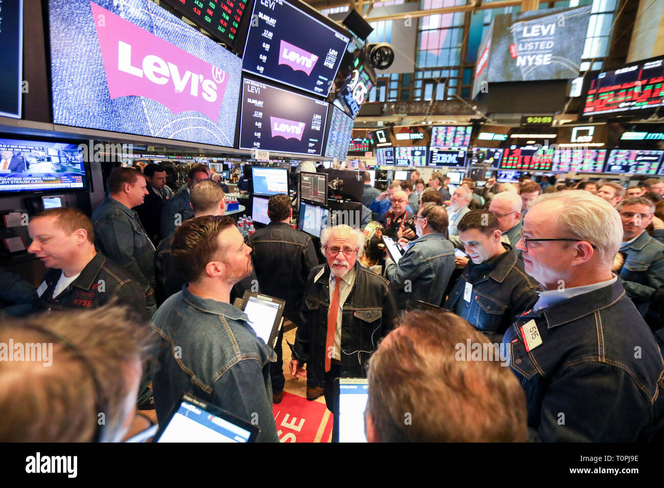New York, USA. 21st Mar, 2019. Traders wearing denim clothing and jeans work at the New York Stock Exchange (NYSE) during the initial public offering (IPO) of Levi Strauss & Co., in New York, the United States, March 21, 2019. Blue jeans giant Levi Strauss & Co. began trading on the NYSE on Thursday. The 166-year-old company first went public in 1971, but has been private for the last 34 years. Credit: Wang Ying/Xinhua/Alamy Live News Stock Photo