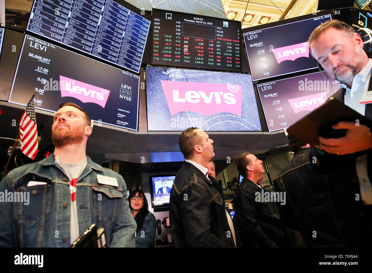 New York, USA. 21st Mar, 2019. Traders wearing denim clothing and jeans work at the New York Stock Exchange (NYSE) during the initial public offering (IPO) of Levi Strauss & Co., in New York, the United States, March 21, 2019. Blue jeans giant Levi Strauss & Co. began trading on the NYSE on Thurday. The 166-year-old company first went public in 1971, but has been private for the last 34 years. Credit: Wang Ying/Xinhua/Alamy Live News Stock Photo