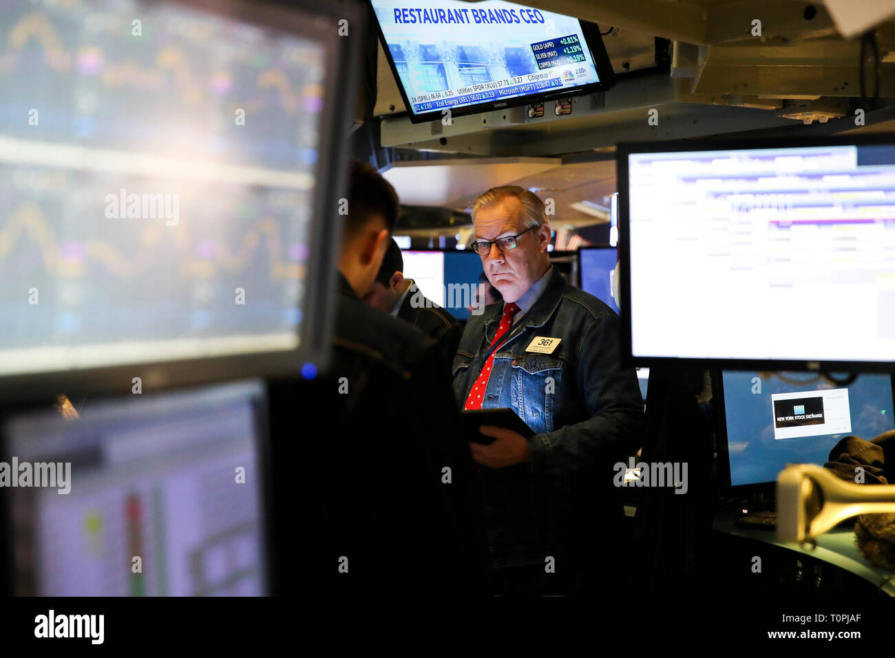 New York, USA. 21st Mar, 2019. Traders wearing denim clothing and jeans work at the New York Stock Exchange (NYSE) during the initial public offering (IPO) of Levi Strauss & Co., in New York, the United States, March 21, 2019. Blue jeans giant Levi Strauss & Co. began trading on the NYSE on Thurday. The 166-year-old company first went public in 1971, but has been private for the last 34 years. Credit: Wang Ying/Xinhua/Alamy Live News Stock Photo