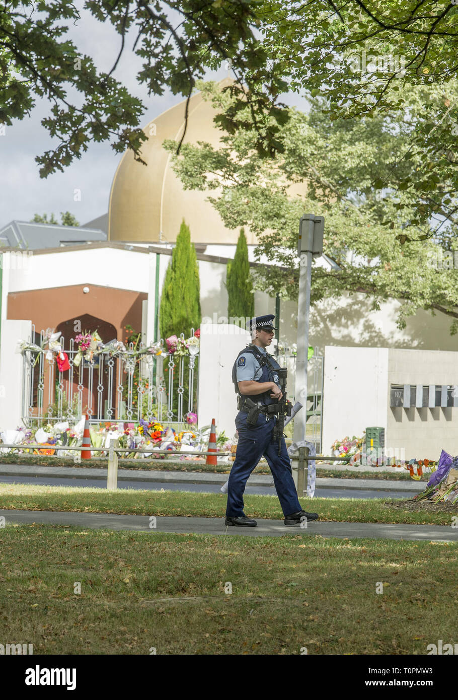 Christchurch, Canterbury, New Zealand. 22nd Mar, 2019. A police officer walks in front of the Al Noor mosque during a Call to Prayer service that attracted thousands of people. The mosque, one of two where a gunman attacked killing a total of 50 people people, is expected to be turned back to the community tomorrow. Credit: PJ Heller/ZUMA Wire/Alamy Live News Stock Photo