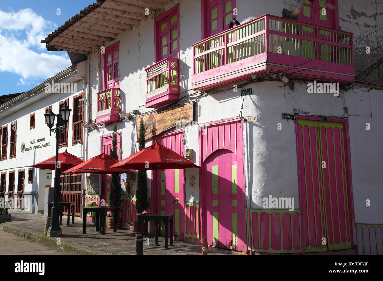 Brightly painted shops, bars and restaurants in the town of Salento in Quindío district of Colombia.Paisa style architecture and built of adobe brick. Stock Photo