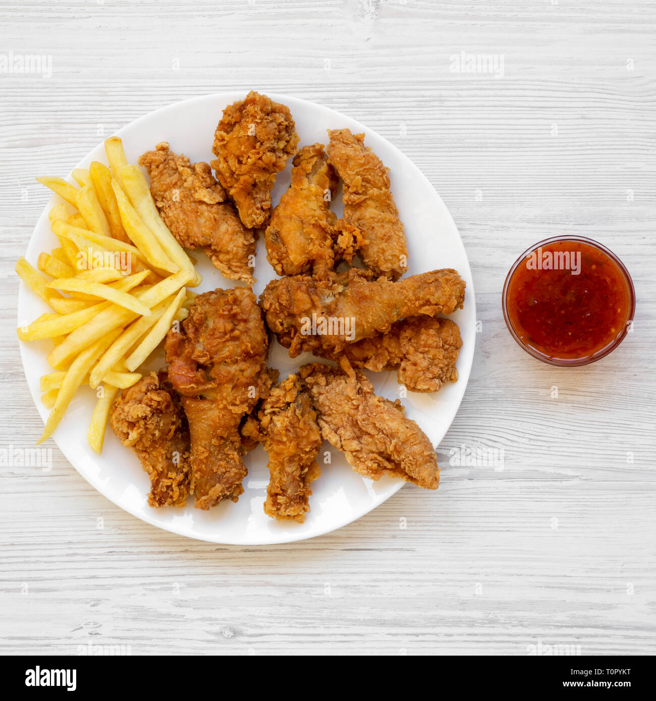 Tasty Fastfood Fried Chicken Legs Spicy Wings French Fries Chicken Strips And Sour Sweet Sauce On White Plate Over White Wooden Background Top Vi Stock Photo Alamy